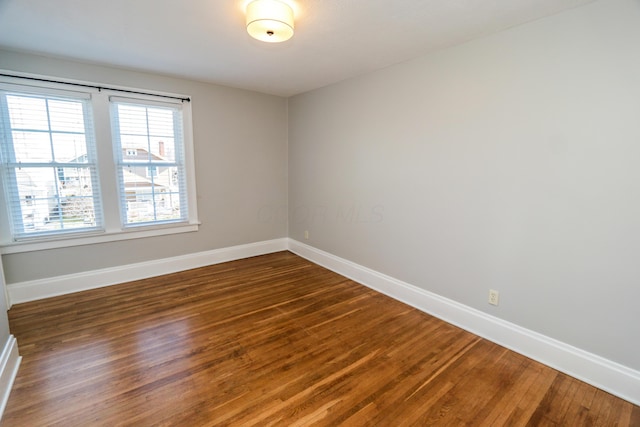 empty room featuring dark hardwood / wood-style flooring