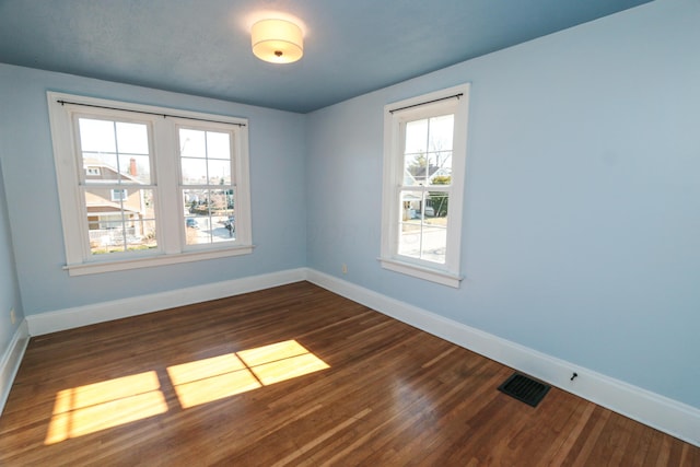 unfurnished room featuring dark wood-type flooring