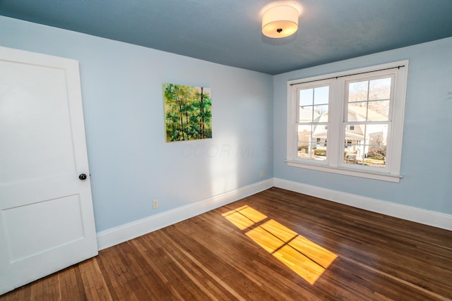 empty room with wood-type flooring