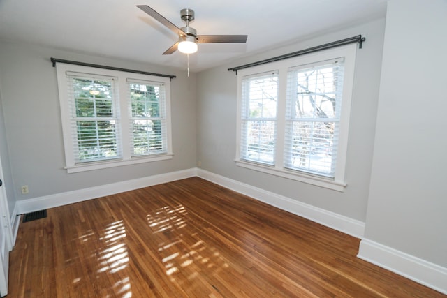 spare room with ceiling fan, a healthy amount of sunlight, and wood-type flooring