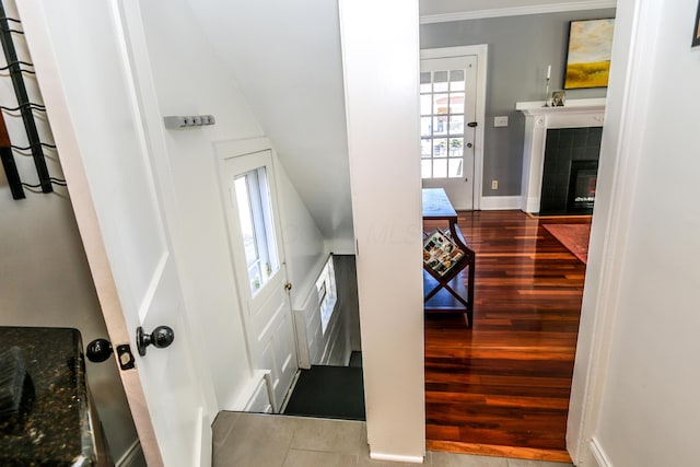 stairs with hardwood / wood-style flooring and a fireplace