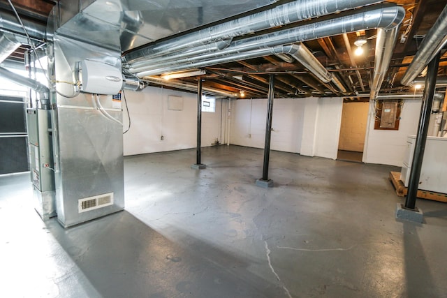 basement featuring heating unit and washer / dryer