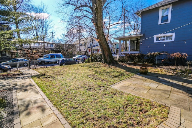 view of yard with a patio and covered porch