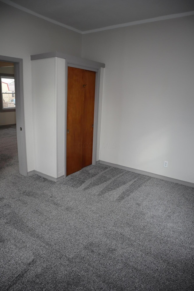 carpeted spare room featuring ornamental molding