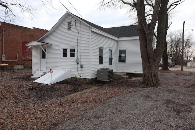 back of house with central AC unit