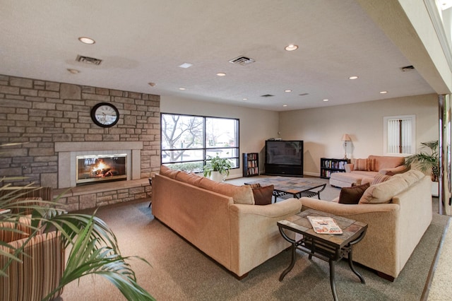 carpeted living room featuring a textured ceiling