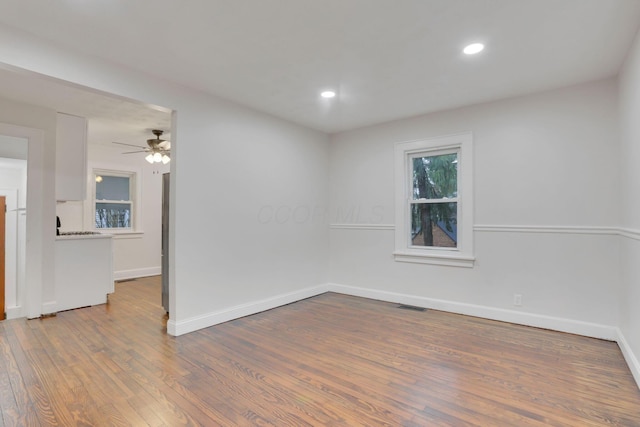 unfurnished room featuring hardwood / wood-style flooring and ceiling fan