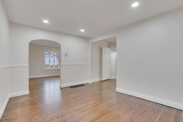 spare room with dark hardwood / wood-style flooring