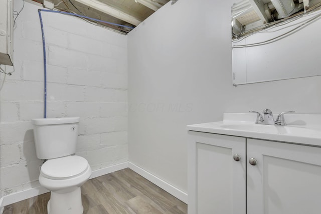 bathroom featuring hardwood / wood-style flooring, vanity, and toilet