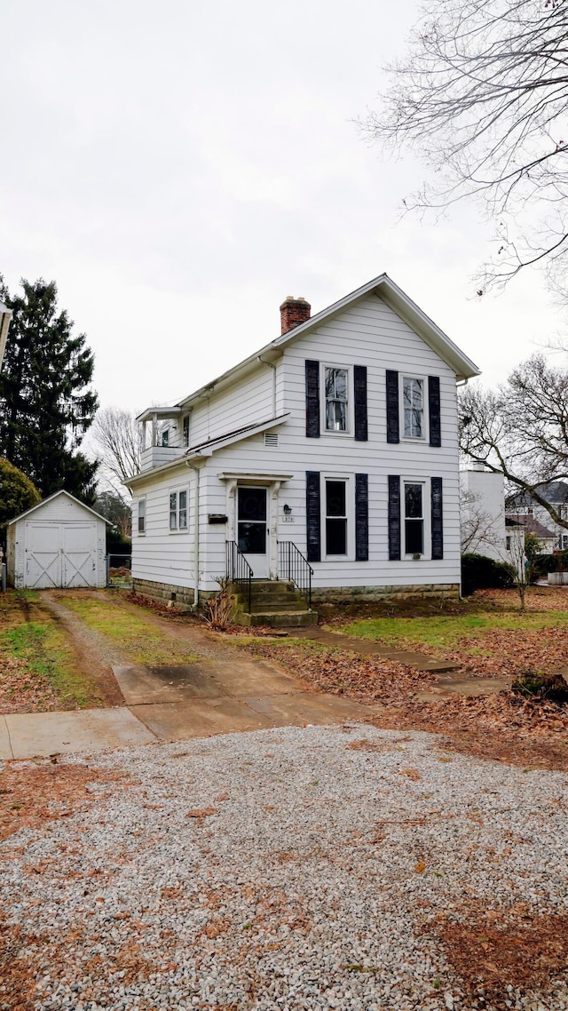 view of front of house featuring a storage shed