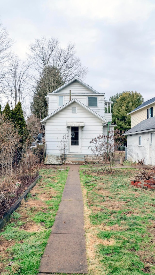 back of property featuring a lawn