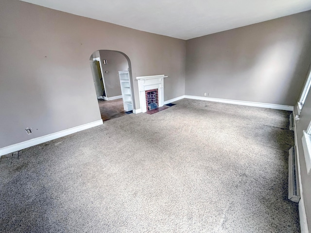 unfurnished living room featuring dark colored carpet