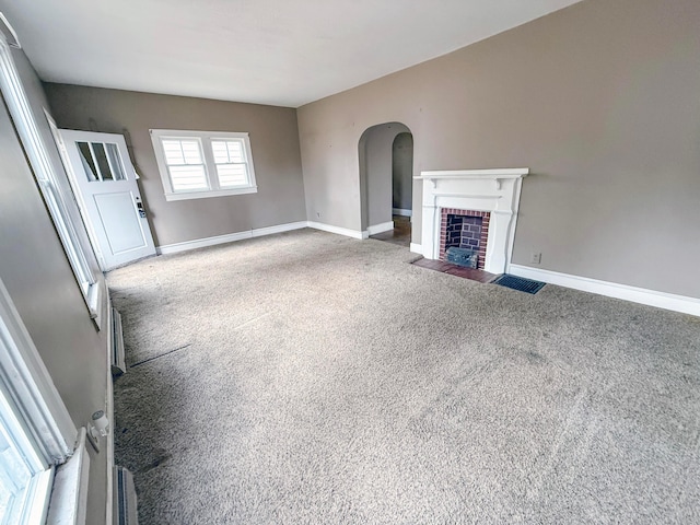 unfurnished living room with dark carpet