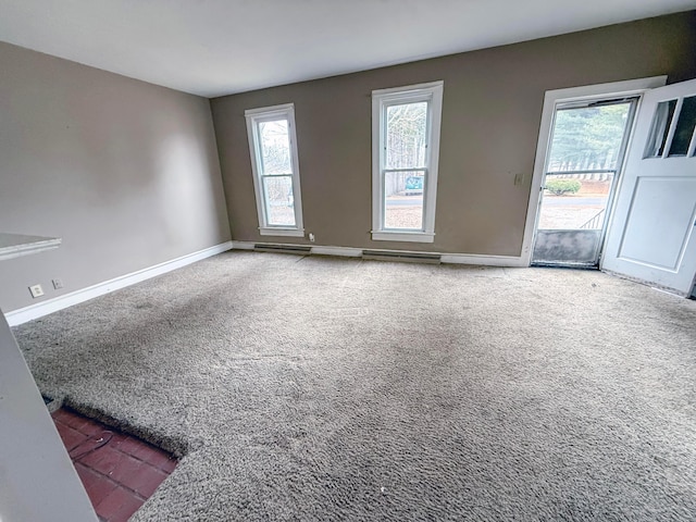 unfurnished room featuring carpet and a wealth of natural light