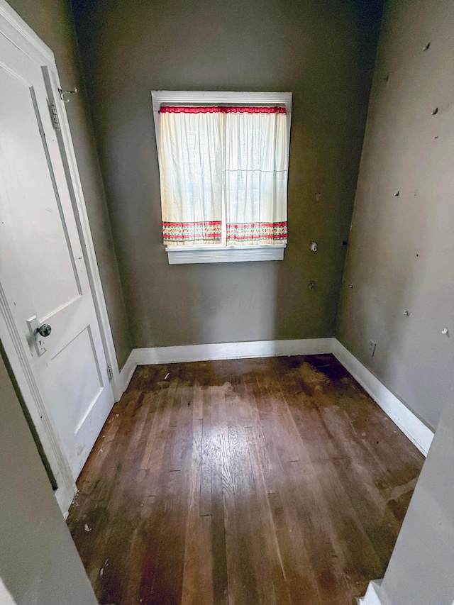 empty room featuring dark wood-type flooring