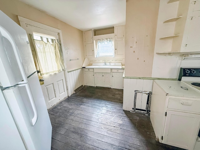 kitchen featuring white refrigerator, white cabinetry, dark wood-type flooring, and electric stove