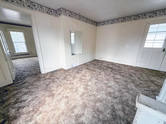 unfurnished room featuring carpet