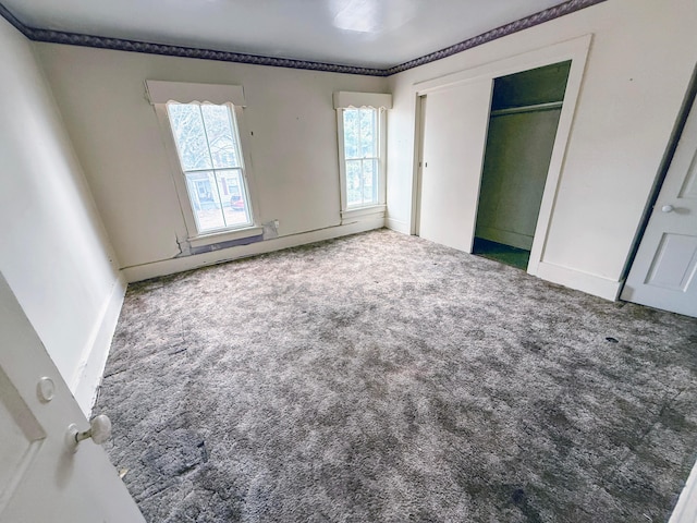 unfurnished bedroom with carpet and a closet