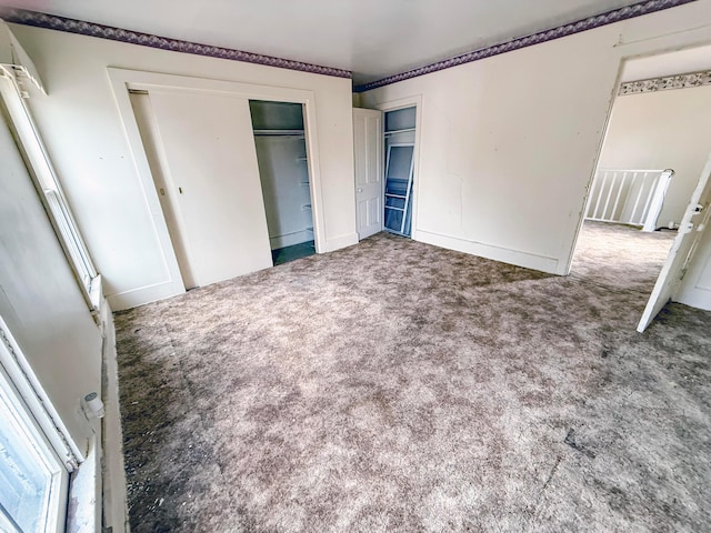 unfurnished bedroom featuring carpet floors and a closet