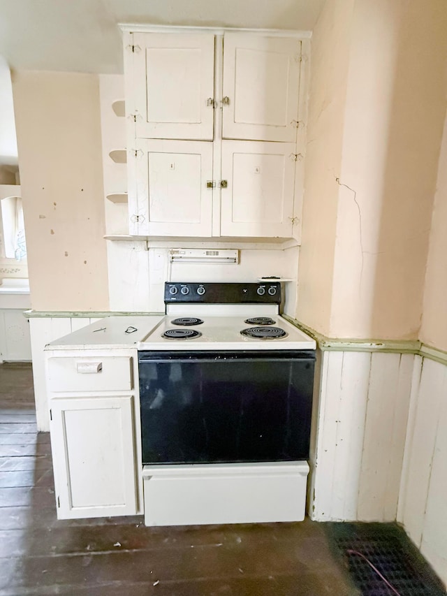 kitchen featuring white cabinets, dark hardwood / wood-style flooring, and electric stove