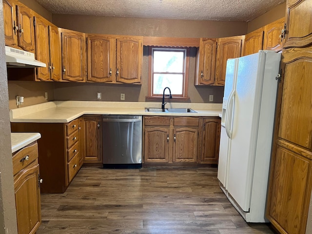 kitchen featuring sink, white fridge with ice dispenser, stainless steel dishwasher, and dark wood-type flooring