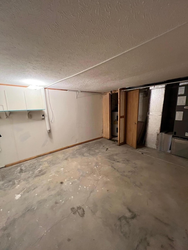 basement with water heater and a textured ceiling