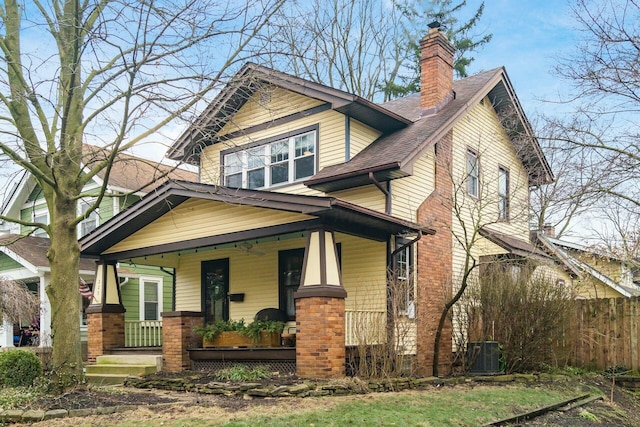 craftsman inspired home with cooling unit and a porch