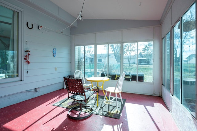 sunroom / solarium featuring lofted ceiling