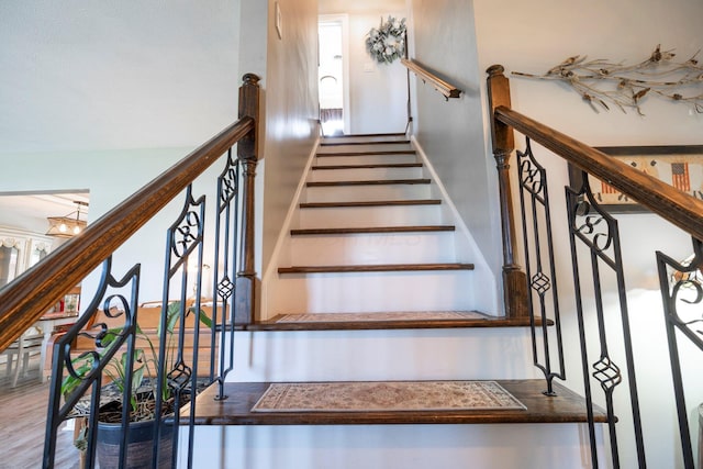 stairs with an inviting chandelier