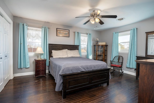 bedroom with baseboards, visible vents, ceiling fan, and dark wood-style flooring