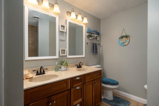 bathroom with toilet, tile patterned flooring, visible vents, and a sink