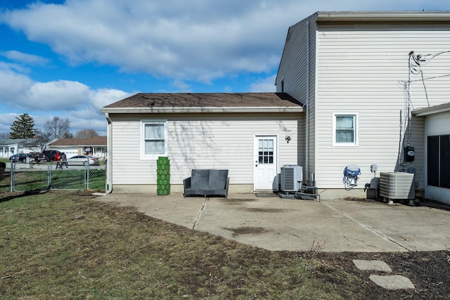 back of house with a lawn, fence, central AC, and a patio