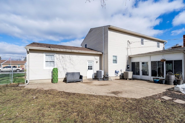 back of house featuring central AC unit, a lawn, a patio area, and fence