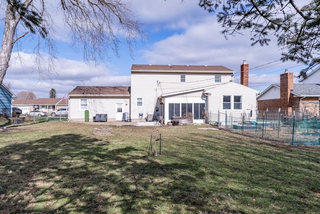 rear view of house with a patio area, a fenced backyard, and a yard