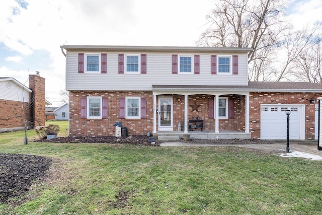 view of front of property featuring an attached garage, a front yard, and brick siding