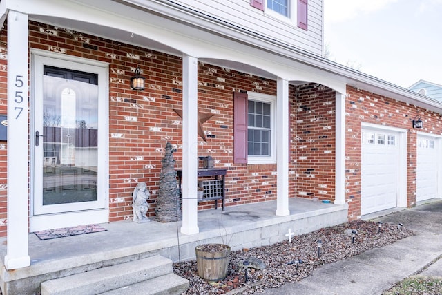 doorway to property featuring brick siding, a porch, and an attached garage