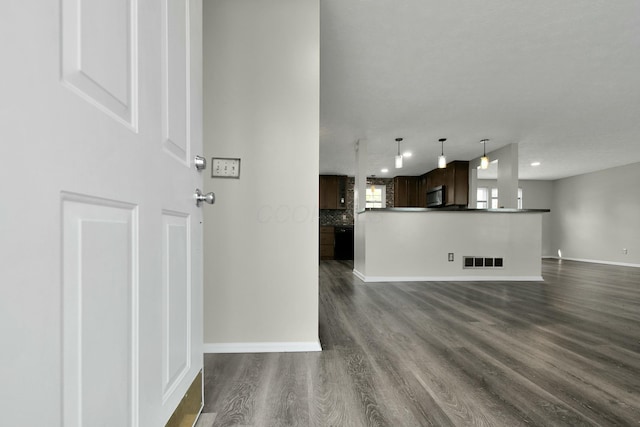 unfurnished living room with dark wood-type flooring