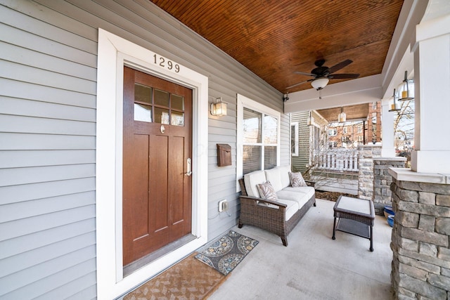 doorway to property with ceiling fan and covered porch