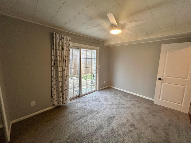 empty room with ceiling fan and dark carpet