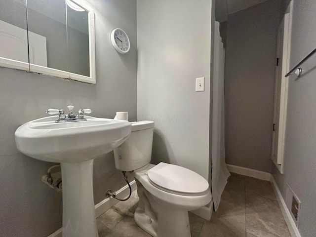 bathroom with tile patterned floors and toilet