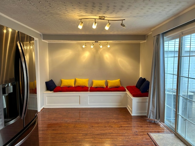 living area with dark hardwood / wood-style flooring and a textured ceiling