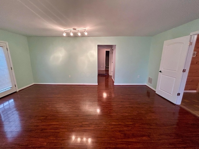 unfurnished room featuring dark hardwood / wood-style floors