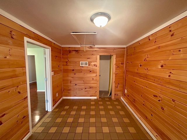 hallway featuring wooden walls