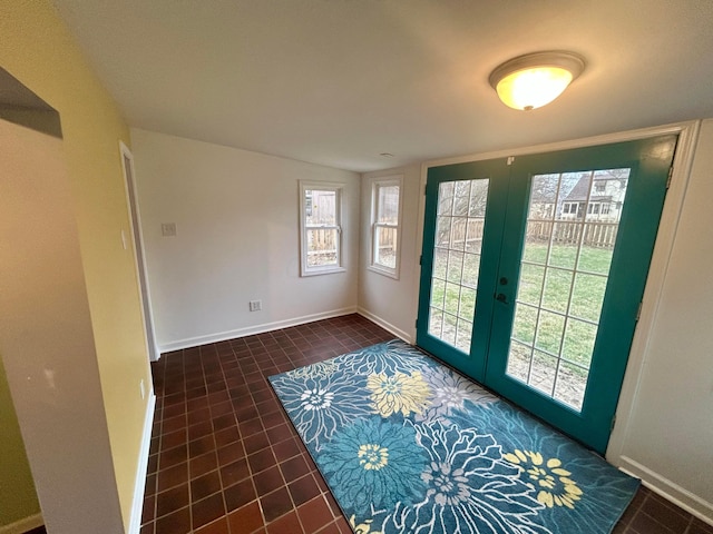 doorway with french doors and dark tile patterned floors