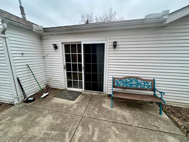 view of exterior entry featuring a patio area