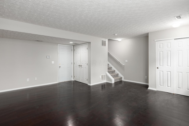 basement with dark hardwood / wood-style floors and a textured ceiling