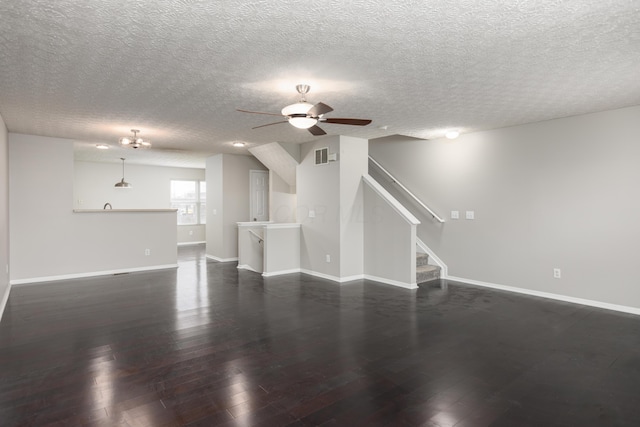 unfurnished living room with dark hardwood / wood-style flooring, a textured ceiling, and ceiling fan