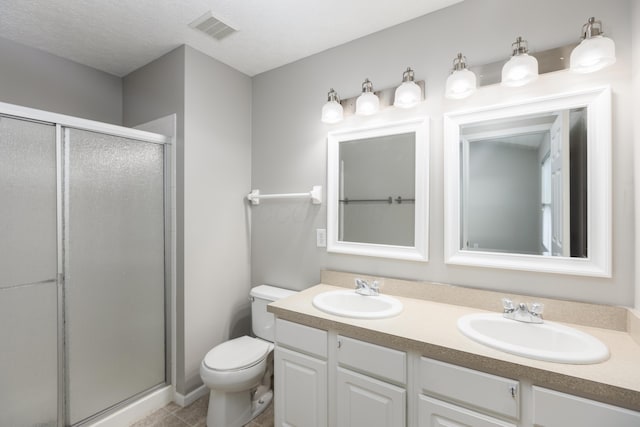 bathroom with walk in shower, vanity, and toilet