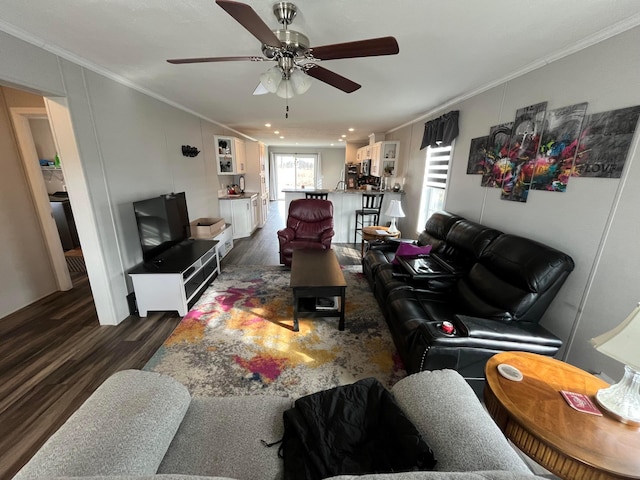 living room with crown molding, ceiling fan, and dark hardwood / wood-style floors