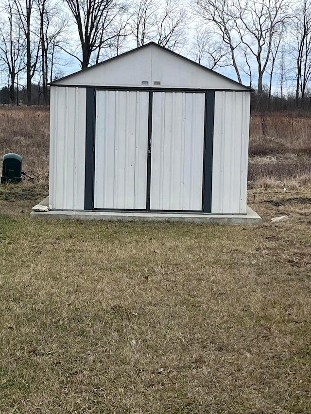 view of outdoor structure featuring a lawn